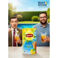 Two men enjoying Lipton Iced Tea Lemon with a pool and garden in the background, featuring the Wakil Ahmed logo.