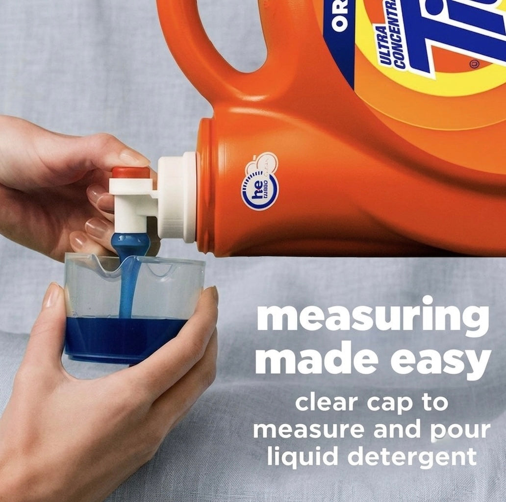 Measuring cap pouring Tide Original HE liquid detergent into a measuring cup