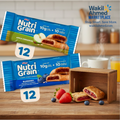 Two packages of Nutri Grain bars on a wooden surface with berries and a wooden box in the background, featuring the Wakil Ahmed Marketplace logo.
