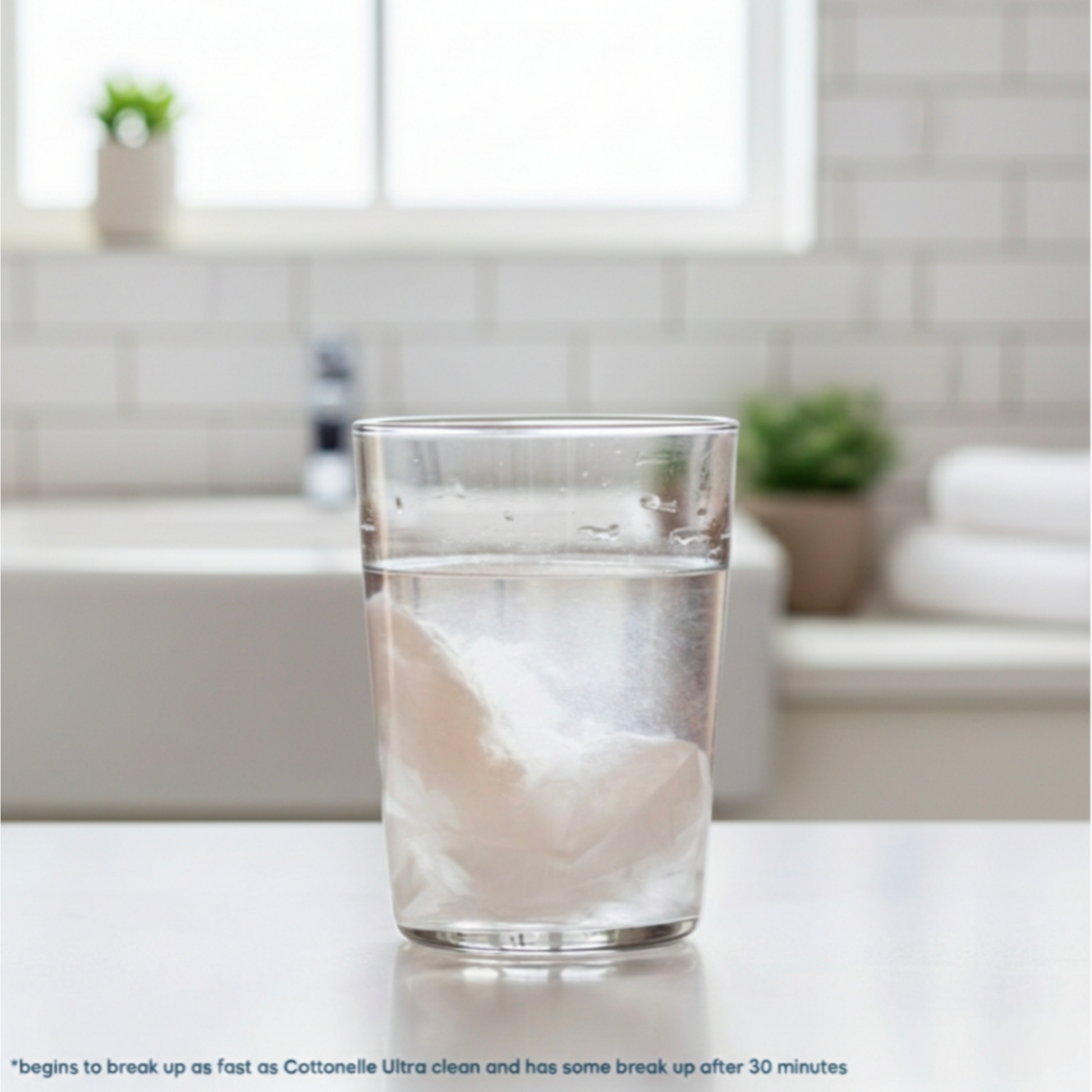 Clear glass of water on a bathroom counter with blurred background