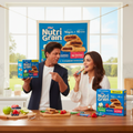 Shahrukh Khan and Juhi Chawla with Nutri Grain boxes in a kitchen setting