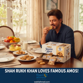 Shah Rukh Khan eating a cookie with Famous Amos packaging on a dining table, featuring Shah Rukh Khan.