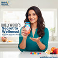 Woman holding a bottle labeled 'Wakil Ahmed' with text about digestive health in a kitchen setting.